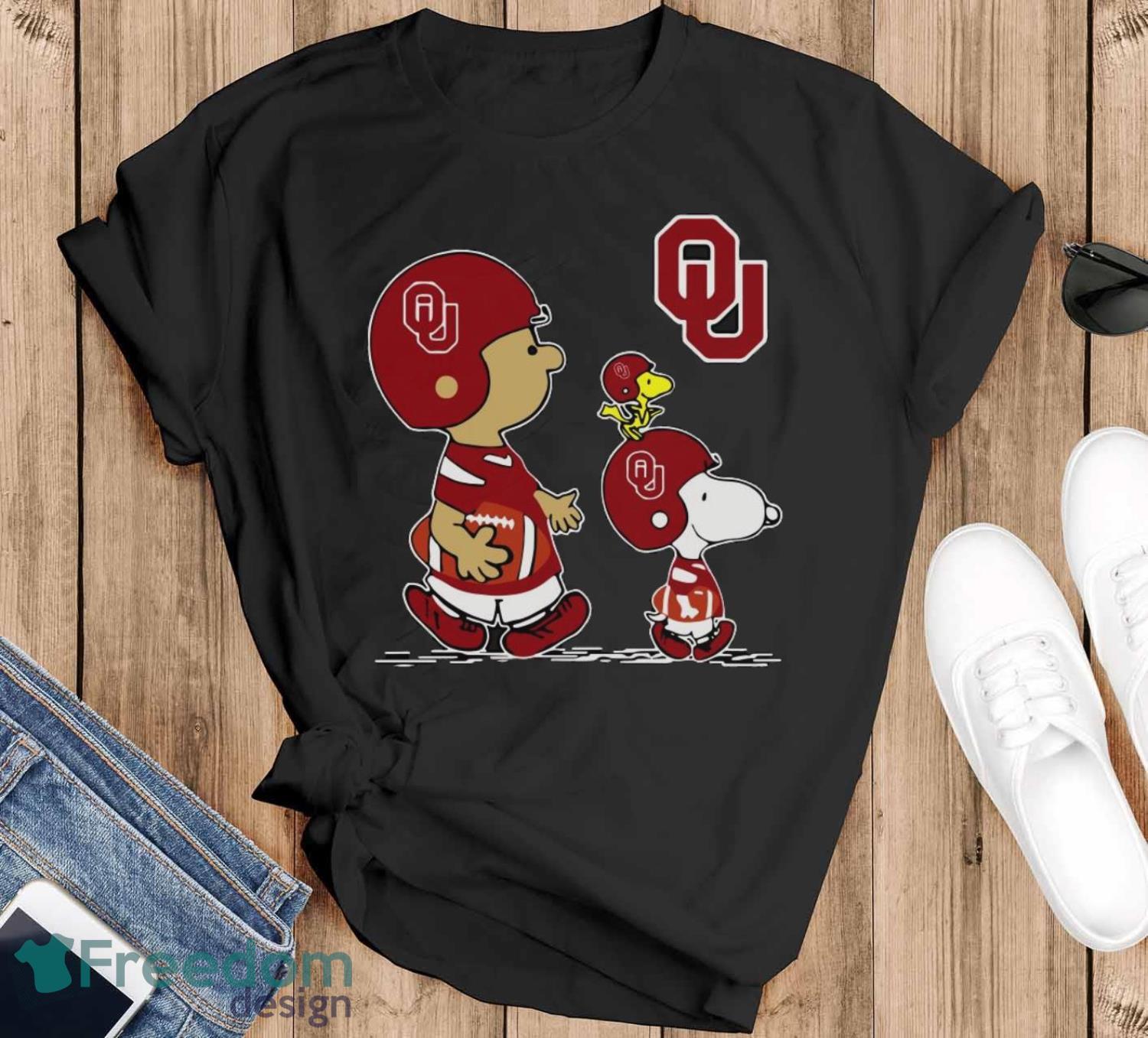 Official The Peanuts Charlie Brown Snoopy Woodstock Oklahoma Sooners Football Shirt image Official The Peanuts Charlie Brown Snoopy Woodstock Oklahoma Sooners Football Shirt - Black T-Shirt