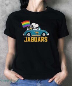 Official NFL Jacksonville Jaguars Snoopy and Woodstock driving car Pride Month 2024 t-shirt - Ladies T-Shirt