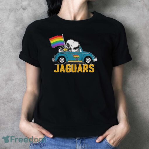 Official NFL Jacksonville Jaguars Snoopy and Woodstock driving car Pride Month 2024 t-shirt - Ladies T-Shirt